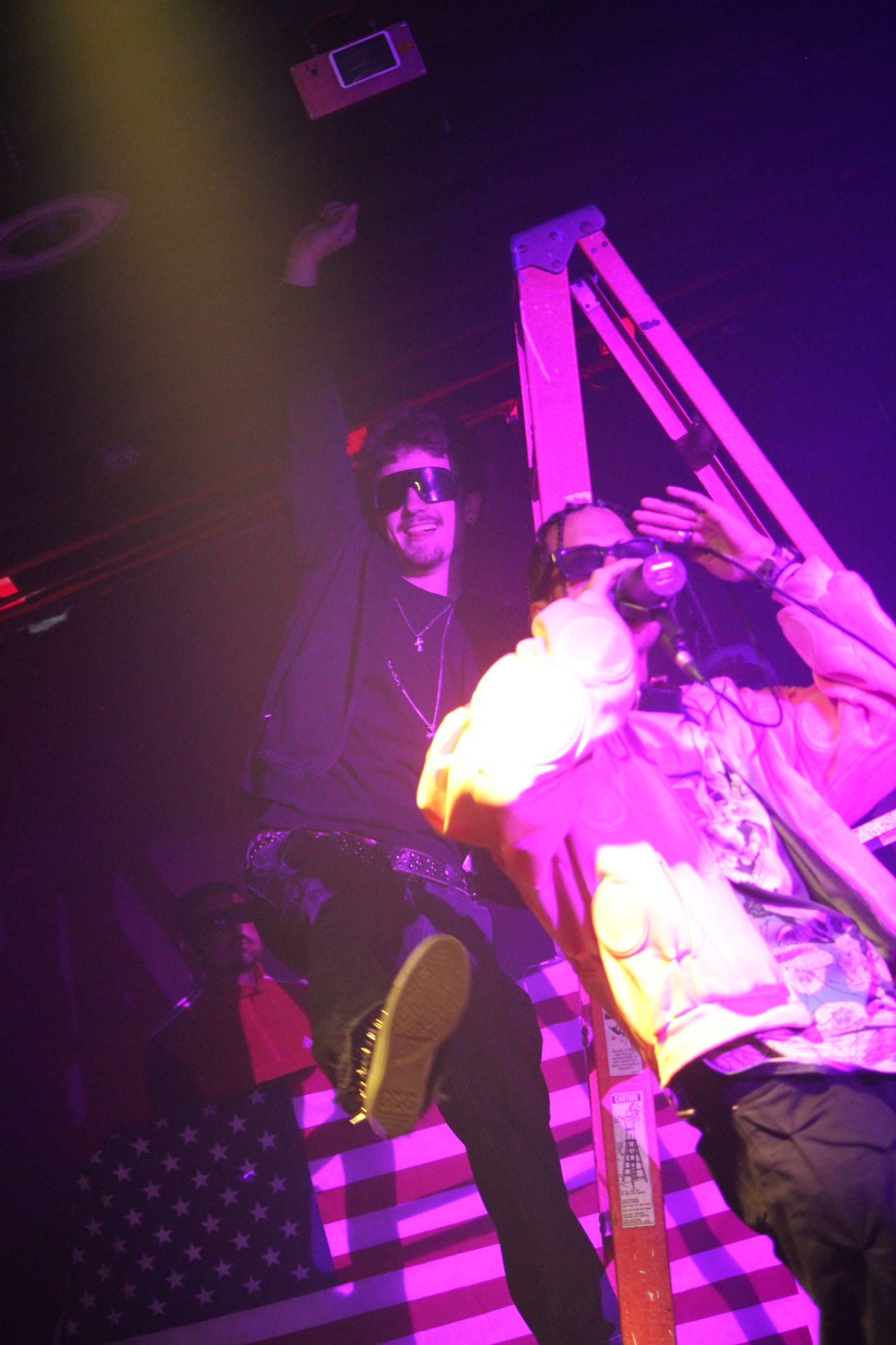 Performer atop ladder during a UT.GMFU show