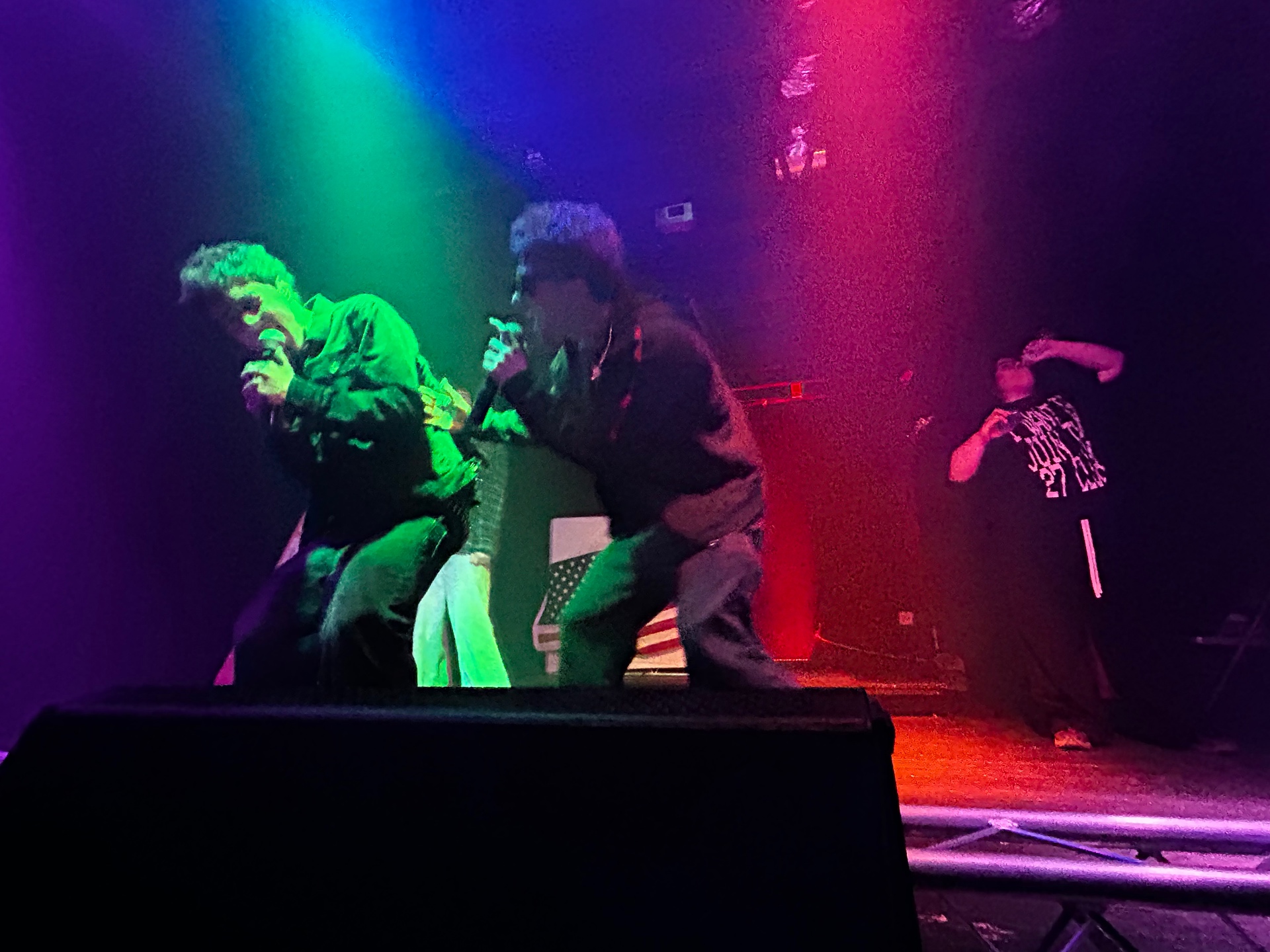 Artists hyping the crowd under stage lights