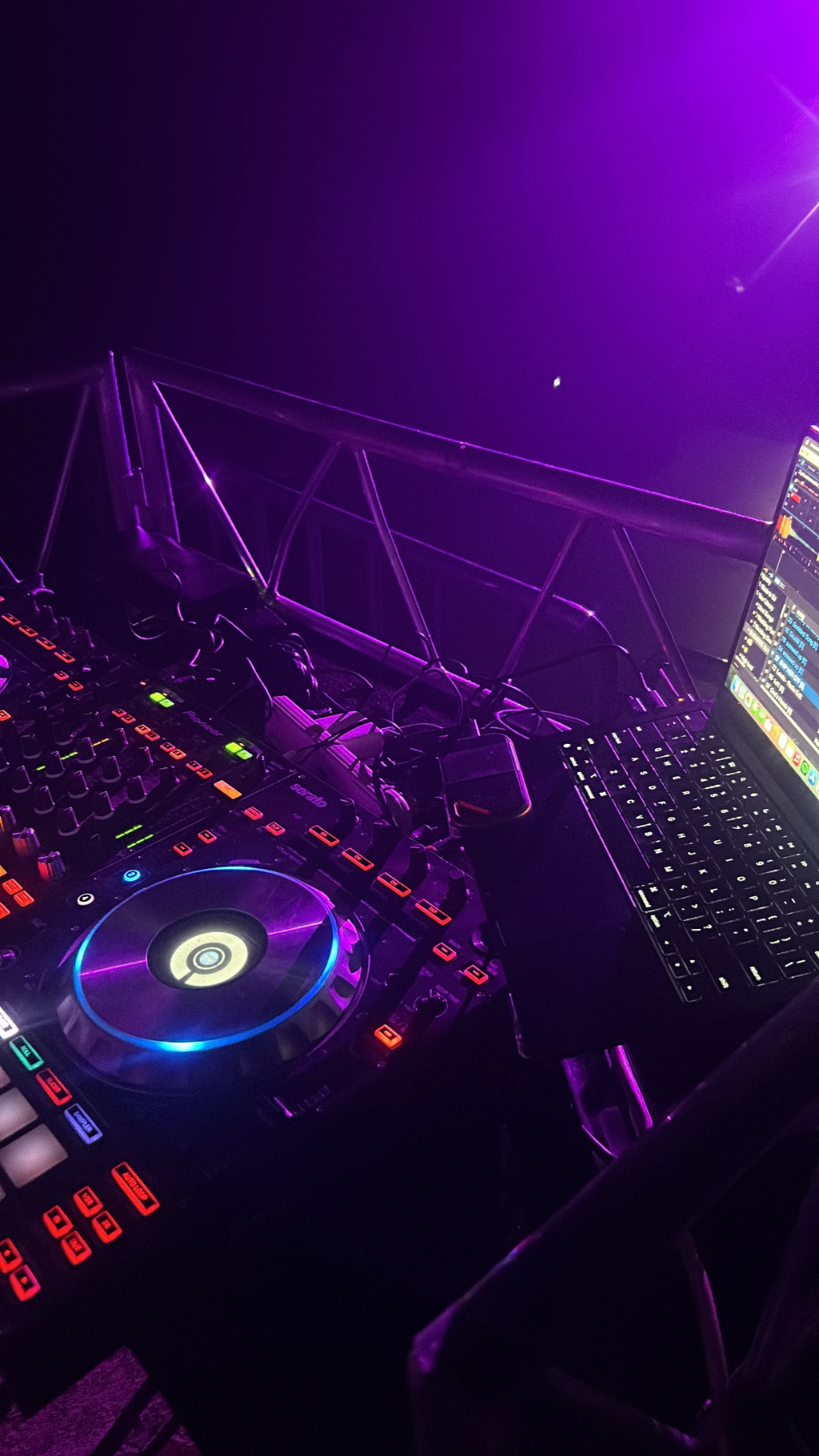 Pioneer DJ controller glowing under purple lights